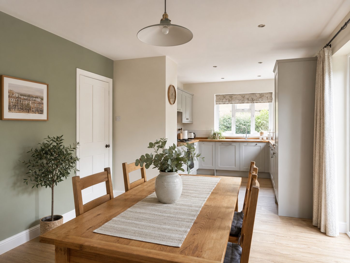 AI-generated concept preview of a completed kitchen-dining room with warm neutral walls, a sage accent wall and white woodwork